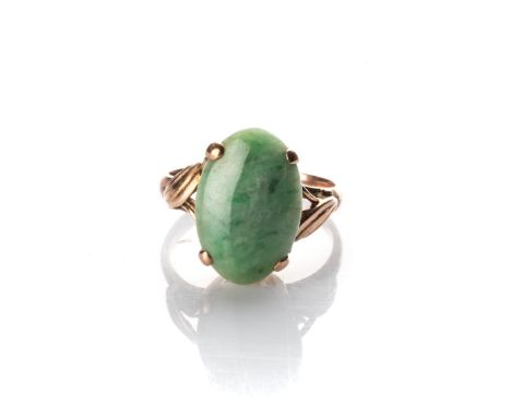 A JADE RING Claw-set to the centre with an oval jade, with leaf design on the sides in 14ct yellow gold, size J 