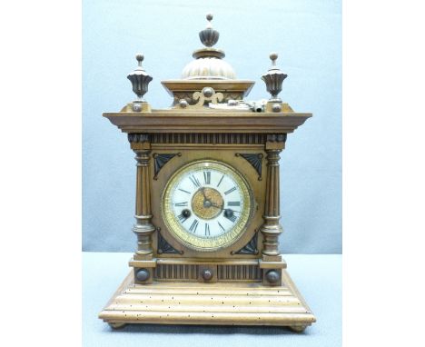 GERMAN WALNUT CASED MANTEL CLOCK architectural style with enamel dial set with Roman numerals before a pendulum driven gong s