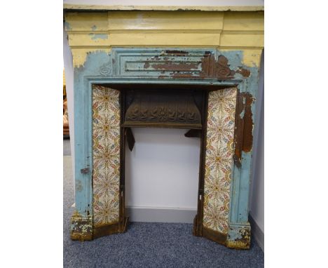 VICTORIAN CAST IRON FIRE SURROUND with mantel shelf and inset colourful tiles, 114cms H, 111cms max W