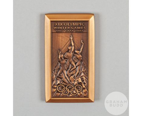 Salt Lake City, 2002 Winter Olympic Games medal by O C Tanner, bronze, the obverse depicting three athletes above Olympic Rin