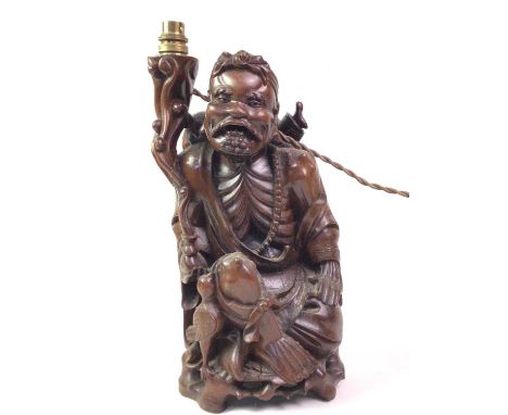 CHINESE CARVED ROOTWOOD FIGURAL LAMP, modelled as a seated man with bird39cm high 