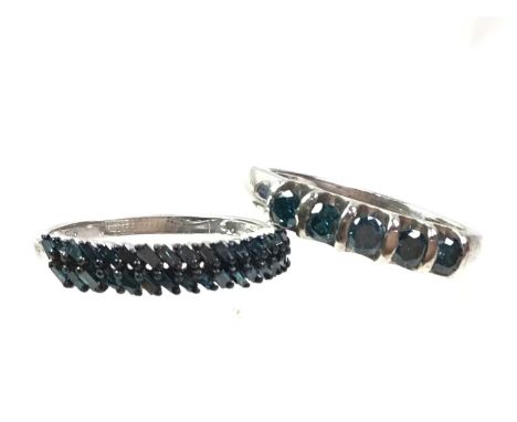 FOUR TREATED BLUE DIAMOND RINGS, three in silver, one in nine carat white gold, sizes Q - RQty: 9k = 2g