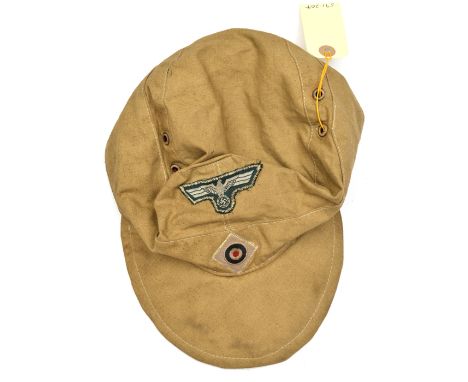 A Third Reich Army tropical ski cap,  the white on green eagle with zig zag stitching, the cockade on pale grey square, with 