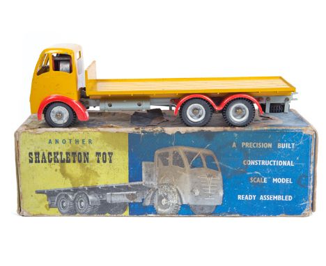A Shackleton Clockwork Foden Flatbed lorry. An FG example with yellow cab and flatbed, red wheel arches and 10 wheels with ru