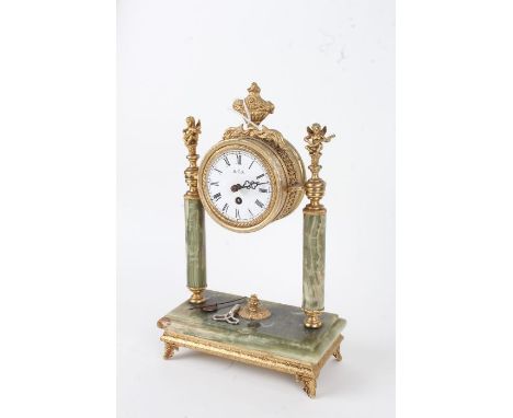 20th century onyx and brass portico clock, having white dial with black Roman numerals, mounted with an urn, flanked by cheru