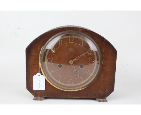 Smiths Enfield mantel clock, with arched case, the pierced brass effect dial with Arabic numerals, 23cm wide