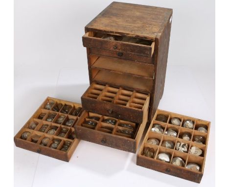 Small wooden chest of six drawers containing wrist and pocket watch glasses, various sizes (qty)