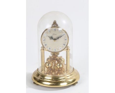Kern Germany anniversary clock, the dial with Roman numerals above four rotating gilt orbs, housed under a glass dome, 21cm h