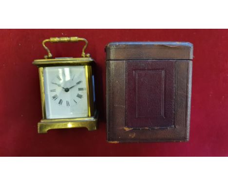 A brass carriage timepiece, with white enamel dial, case