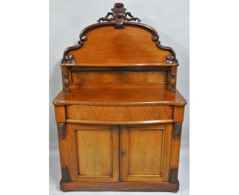 A Victorian mahogany chiffonier, the shaped back with shelf, over a serpentine frieze drawer, over two cupboard doors, 195 x 