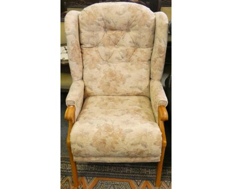 A pocket sprung button back armchair in beige floral fabric 