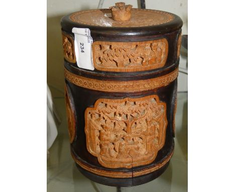 A wooden circular tea caddy, lead lined with carved wooden panels 
