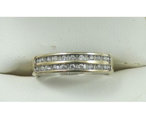 An 18ct white gold and diamond eternity ring, channel set with a double row of brilliant cut stones, stated weight 0.25 cts, 