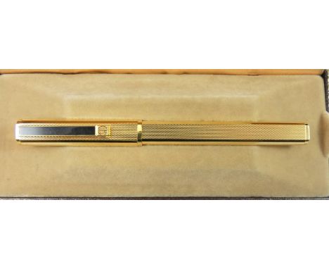 Dunhill, a gilt metal Gemline fountain pen, with engine turned body, 18K gold knib, warranty card, booklet, cartridges, cloth