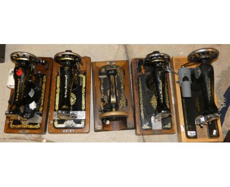 Six manual sewing machines plus one electric example