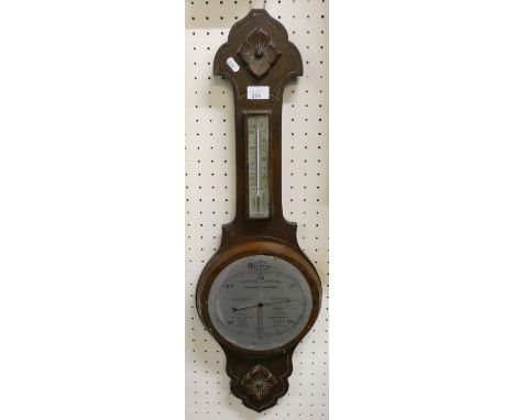 An oak framed barometer in need of new glass 