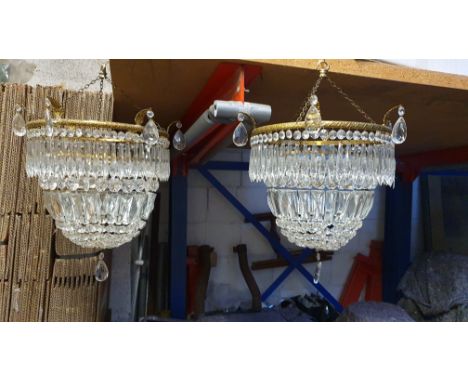 A pair of glass droplet and gilt metal light shades lacking electrical fittings