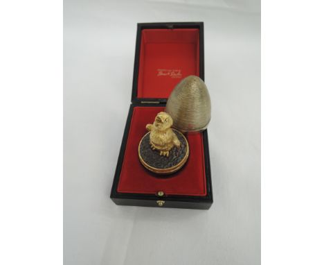 A Stuart Devlin silver gilt surprise egg for year 1972, containing a silver gilt chick on oxidised ground and having a textur