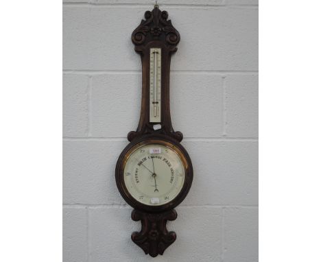 An early 20th century oak frame banjo barometer by J Taylor having thermometer