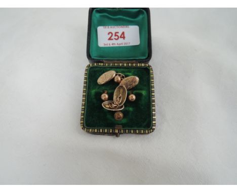 A cased set of four rolled gold collar studs and a pair of 9ct gold cufflinks of lozenge form having chain connectors and eng