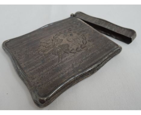 A silver card case of shaped form having engine turned and scroll & bow decoration, Birmingham 1911, Henry Matthews