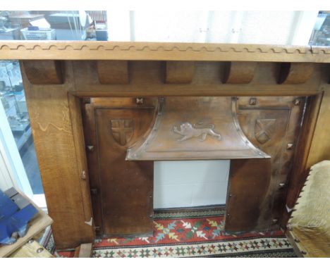 An early/mid 20th century golden oak adzed fire surround by Mouseman, Robert Thompson of Kilburn having castlelated top and c