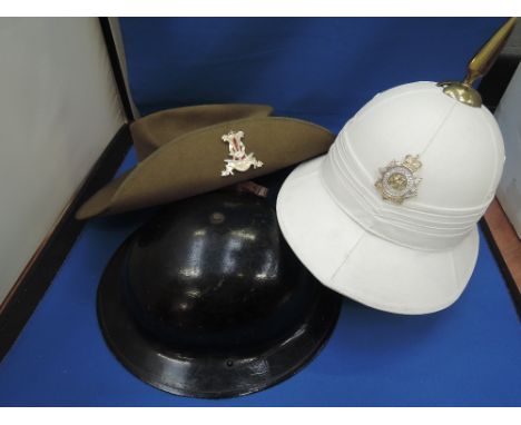 A box containing three military hats, Australian pith helmet and slouch hat, Army Air Raid Warden helmet