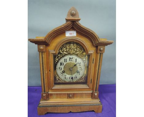 An early 20th century bleached case mantel clock having architectural detail with brass spandrels 