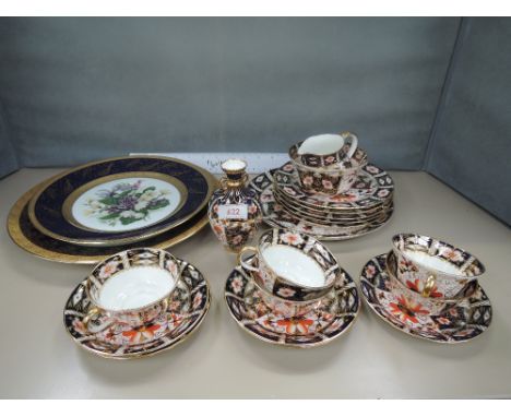 A Royal Crown Derby part tea service in the Imari palette, a similar vase and two handpainted Limoges plates