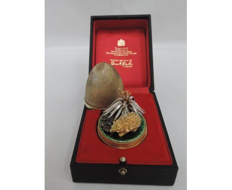A Stuart Devlin silver gilt surprise egg for year 1978, Limited edition no 170, containing a gilt hedgehog under a silver and