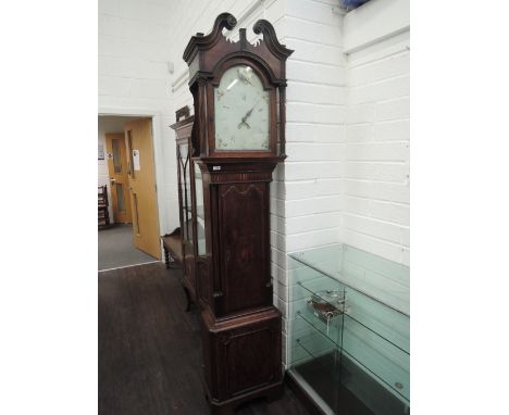 A late 18th century oak longcase clock having swan neck and pillar hood containing painted face and 30 hour movement on shape