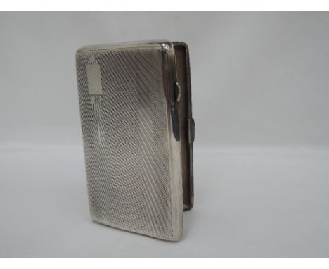 A silver cigarette case having engine turned decoration and Art Deco style plain cartouche, Birmingham 1939, John Rose