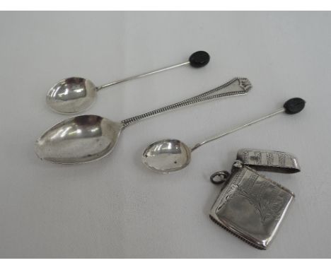 A silver vesta having engine turned and scroll decoration, Chester 1913, E J Trevitt & Sons, and three HM silver teaspoons