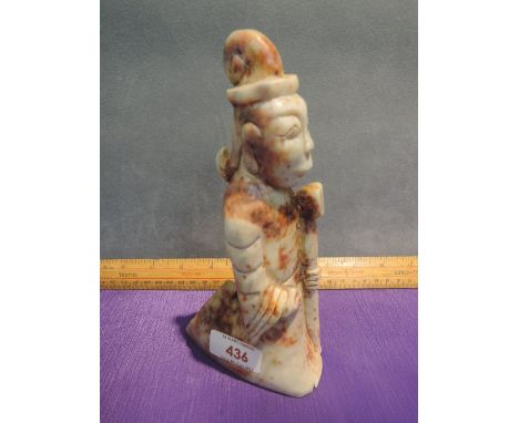 A jade figure modelled as carved kneeling courtier
