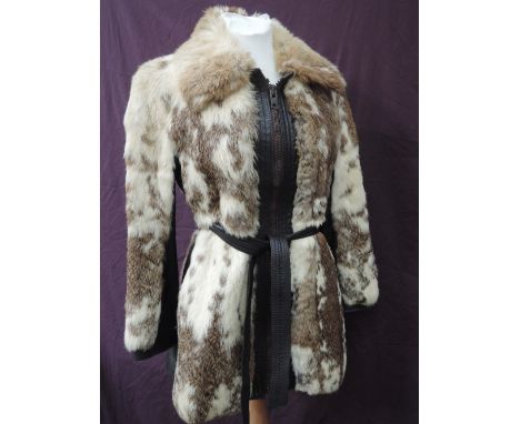 A lady's piebald coney fur and leather zip up jacket having tie leather belt