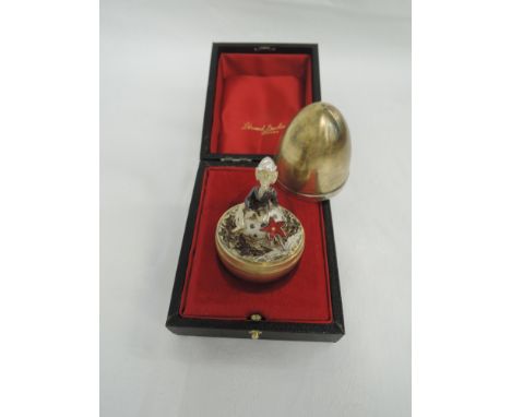 A Stuart Devlin silver gilt surprise egg for year 1975, Limited edition no 170, containing a silver and gilt pixie sitting on