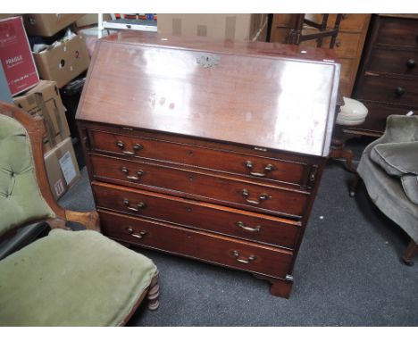A 19th century mahogany bureau having slope front with drawer interior over drawers and bracket feet
