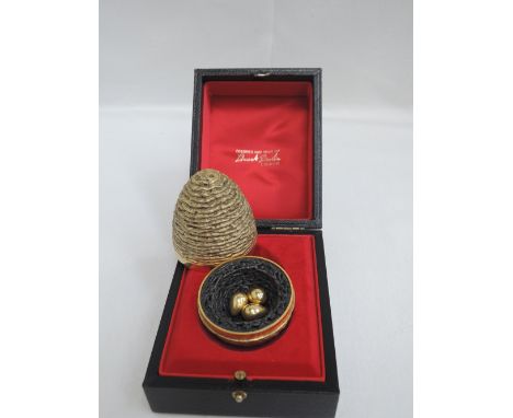 A Stuart Devlin silver gilt surprise egg for year 1971, containing an oxidised bird nest containing three gilt eggs and havin