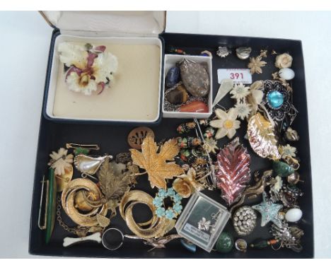 A selection of costume jewellery including Royal Crown Derby ceramic Orchid brooch, clip earrings, brooches etc