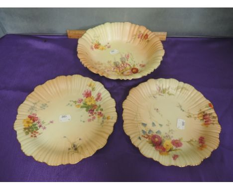 A Royal Worcester fruit bowl and two matching plates having hand painted floral decoration on blush ivory ground, numbered 1/