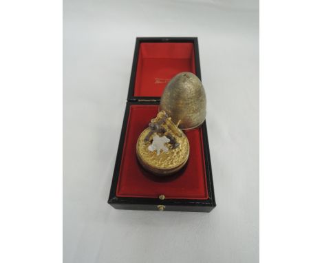 A Stuart Devlin silver gilt surprise egg for year 1977, Limited edition no 170, containing silver and gilt fish with oxidised