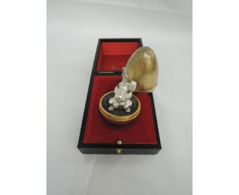 A Stuart Devlin silver gilt surprise egg for year 1974, Limited edition no 170, containing a flop eared silver rabbit and hav