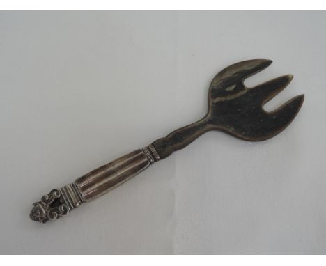 A Danish silver handled horn salad serving fork in the acorn design by Georg Jensen 