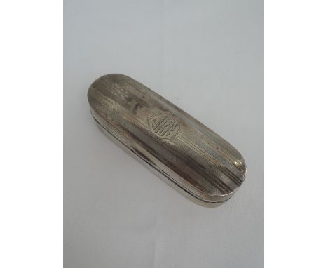 A silver trinket box of oval form having engine turned stripe decoration and monogram to cartouche, Birmingham 1918, Deakin &