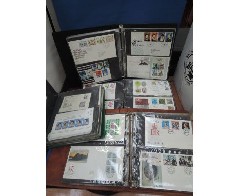 A box containing six GB First Day covers and stamp albums