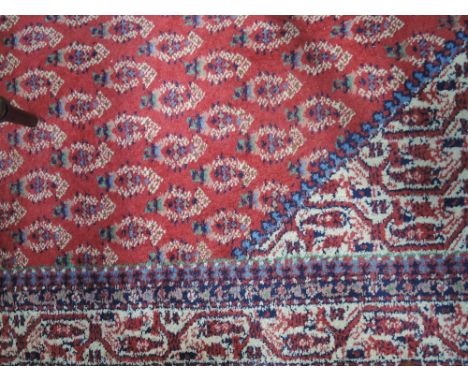 A 20th century carpet square of semi Teke design having red, blue and cream ground