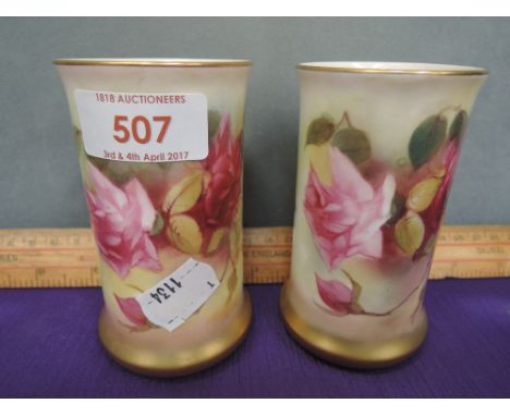 A pair of Royal Worcester spill vases having painted rose decoration by E M Fildes, numbered 2510