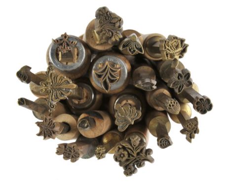 *Decorative finishing tools. Twenty brass decorative finishing tools, comprising centre tools with flower and/or foliage moti