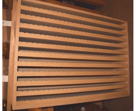 *Finishing tool rack unit. A modern bespoke made finishing tool rack, for wall mounting, finished in oak veneer, with eleven 