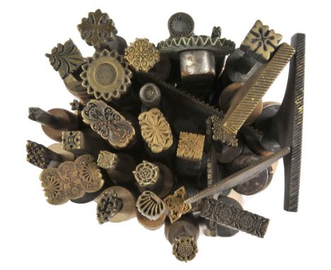 *Decorative finishing tools. Twenty-three brass decorative finishing tools, comprising centre tools with traditional designs,